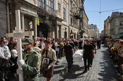 People attend a funeral procession for Yevhenia Bazylevych and her three daughters, killed during the Russian missile attack on September 4 as Yaroslav her husband, was the only survivor out of the entire family, amid Russia's attack on Ukraine, in Lviv, Ukraine September 6, 2024. REUTERS/Roman Baluk