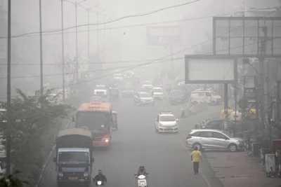 People drive through smog India