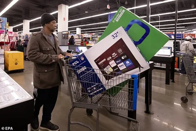 A customer purchases televisions at a Walmart on Black Friday in Washington, DC, USA, 24 November 2023