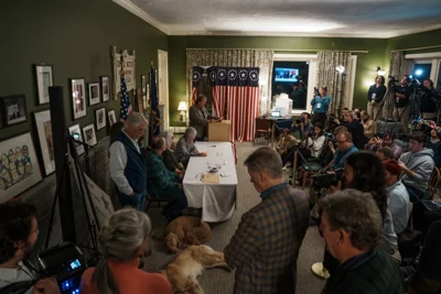 Residents, officials and press gather in Dixville Notch on Monday evening to cast their votes in the presidential election