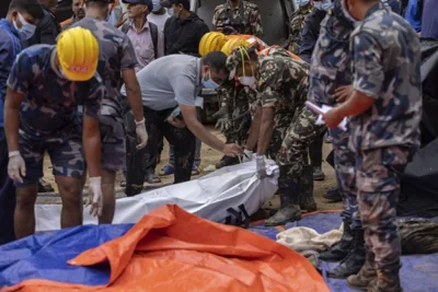 MORBID GATHERING Members of a rescue team collect the corpses of passengers of the buses buried in a landslide at Jhyaple Khola, Dadhing district, northern Nepal, on Sept. 29, 2024. EPA PHOTO