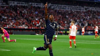 Vinicius Jr's double earns Real Madrid 2-2 draw at Bayern 
