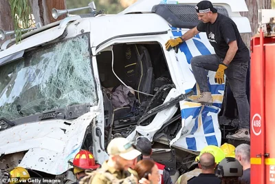 Israeli police inspect the body of the truck driver at the site of a ramming attack in Ramat Hasharon, north of Tel Aviv on October 27, 2024