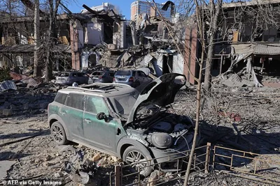 This photograph taken on November 25, 2024 shows destroyed cars next to a destroyed building following a missile attack in Odesa