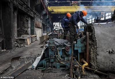 Workers fix a thermal power plant damaged by a Russian missile strike, amid Russia's attack on Ukraine, at an undisclosed location in Ukraine November 28, 2024