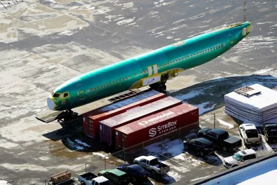 The green body of a 737 Max plane outside a Spirit factory.