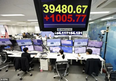 A monitor displays the Nikkei Stock Average at a foreign exchange brokerage in Tokyo on November 6