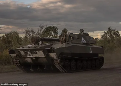 A Ukrainian serviceman drives a self-propelled howitzer 2S1 Gvozdika into Kursk, August 13, 2024