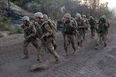 Ukrainian servicemen of the Shkval special battalion, 28th Separate Mechanized Brigade, ex-convicts, take part in military exercises at an unspecified location in the Donetsk region on July 26, 2024. [Anatolii STEPANOV / AFP]