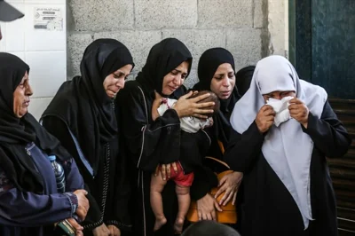 AUGUST 13: Relatives of the Palestinian children who lost their lives as a result of an Israeli attack, mourn as the bodies are brought to the morgue of Al-Aqsa Martyrs Hospital in Deir al Balah, Gaza on August 13, 2024. Photojournalist:Ali Jadallah