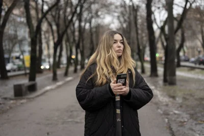 Yevheniia Synelnyk, whose brother has been in captivity for over a year and a half, stands in park in Kyiv, 25 January 2024