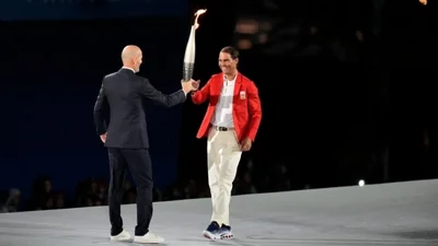 Zinedine Zidane hands the torch over to Rafael Nadal.(AP)