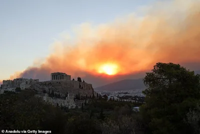 Smoke rises over Parthenon temple during a wildfire near Athens, Greece, on August 12