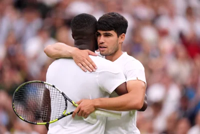 Carlos Alcaraz embraces Frances Tiafoe at the net after their match