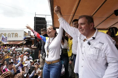 Presidential candidate Edmundo Gonzalez and opposition leader Maria Corina Machado greet supporters at a campaign rally in Barinas, Venezuela, July 6, 2024.