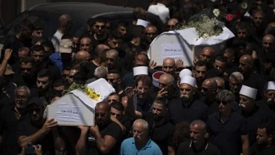 Israel weighs response to Hezbollah after a rocket from Lebanon kills 12 youths on a soccer field