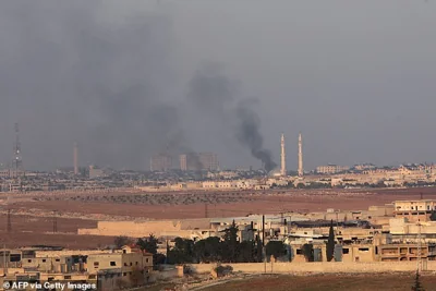 A picture taken from the area of New Aleppo shows smoke rising during clashes between jihadists and Syrian soldiers in the northern city of Aleppo on November 29