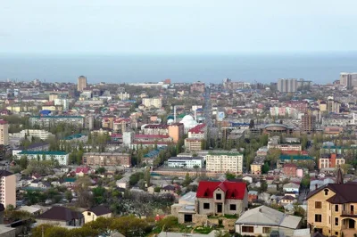A view from above of a city. The Caspian Sea is in the background.