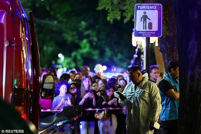 Pictured: A forensic technician uses his phone outside the hotel in the wake of the popstar's sudden death