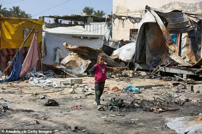 A Palestinian child is seen among the destruction after Israel targeted the tents of displaced civilians in courtyard of Al-Aqsa Martyrs Hospital in Deir al-Balah, Gaza on October 15, 2024