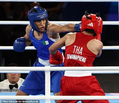 Imane Khalif punches Janjaem Suwannapheng in the face during the Women's 66Kg Boxing semi-final at the Paris 2014 Olympics