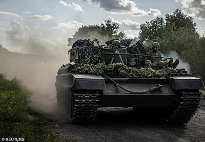 Ukrainian servicemen ride a military vehicle, amid Russia's attack on Ukraine, near the Russian border in Sumy region, Ukraine August 11, 2024