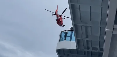 A person is evacuated from the cruise ship in a helicopter