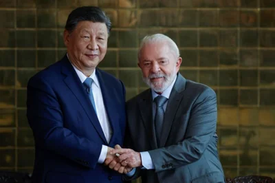 China's Xi Jinping shakes hands with Brazil's Luiz Inacio Lula da Silva