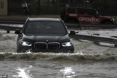 An SUV stalls out while trying to pass through standing water in Dubai, United Arab Emirates, Tuesday, April 16, 2024