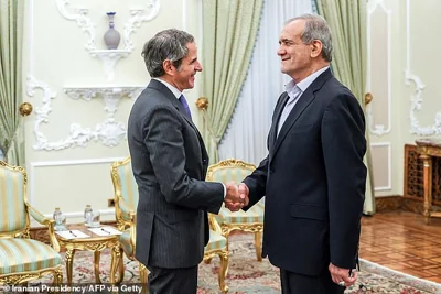 Iran's President Masoud Pezeshkian (R) welcoming International Atomic Energy Agency chief Rafael Grossi (L) during a meeting in Tehran on November 14