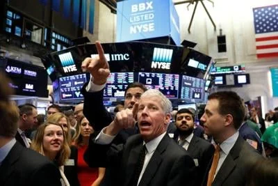 Liberty Oilfield Services Inc. CEO Chris Wright (C) talks with NYSE Group President Thomas Farley while waiting for the companies IPO on the floor of the New York Stock Exchange shortly after the opening bell in New York