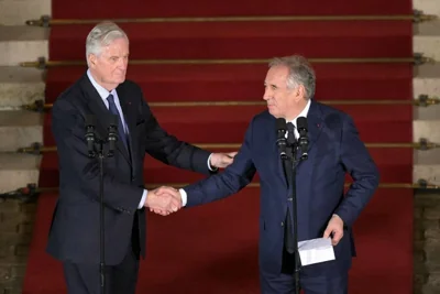 IN AND OUT France’s former prime minister Michel Barnier (left) shakes hands with his successor Francois Bayrou at the end of the handover ceremony at the Hotel Matignon in the capital Paris on Dec. 13, 2024. AFP PHOTO