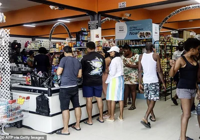 People shop groceries at a supermarket in Scarborough, Trinidad and Tobago, as they prepare for the arrival of Hurricane Beryl on June 30, 2024