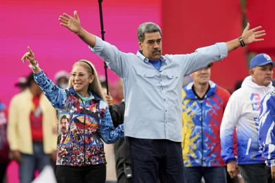 President Nicolas Maduro opens his arms alongside first lady Cilia Flores during his closing election campaign rally in Caracas, Venezuela, Thursday, July 25, 2024.
