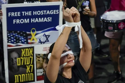 A woman wears a blindfold during a protest in Tel Aviv calling for a ceasefire deal and the immediate release of hostages held in Gaza by Hamas, September 4, 2024