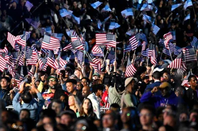 Supporters wave U.S. flags as they watch election results during an election night event for U.S. Vice President and Democratic presidential candidate Kamala Harris at Howard University in Washington, D.C., Nov. 5. AFP-Yonhap