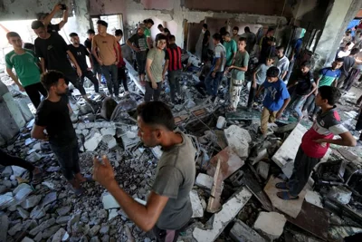 Palestinians search for the bodies of their relatives killed in an Israeli bombardment of a school in Deir al-Balah, central Gaza Strip, Thursday, Oct. 10, 2024. (AP Photo/Abdel Kareem Hana)