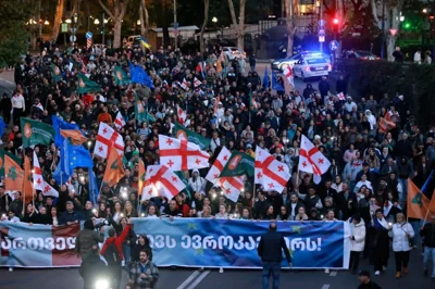 Demonstrators march during an opposition rally ahead upcoming next week parliamentary election in Tbilisi, Georgia, Sunday, Oct. 20, 2024. [AP Photo/Zurab Tsertsvadze]