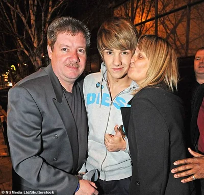 Liam is pictured with his parents after the X Factor final in 2010