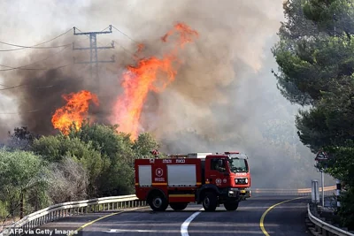 A fire truck arrives at the scene of a fire after rockets fired from southern Lebanon hit an area in the Upper Galilee region in northern Israel on July 4