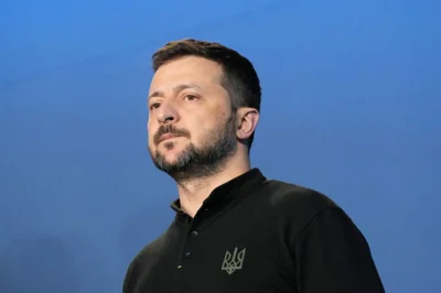 A head and shoulders photo of Volodymyr Zelenskyy. He is wearing black. He looks serious.