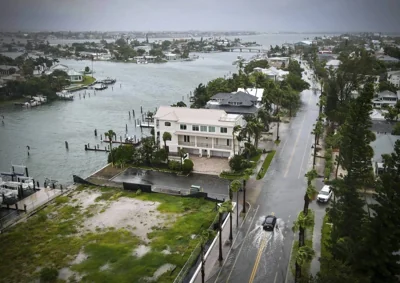 A driver negotiates a flooded street as Tropical Storm Debby passes just to the west of the Tampa Bay, Florida., region, Sunday, Aug. 4, 2024.  MAX CHESNES/TAMPA BAY TIMES VIA AP