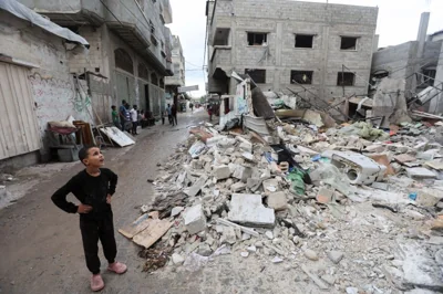 A Palestinian kid looks on at the site of an Israeli strike on a house, amid the Israel-Hamas conflict, in Nuseirat in the central Gaza Strip, October 1, 2024.