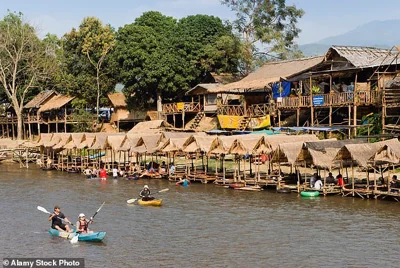 Tourists kayaking in the party town of Vang Vieng in Laos