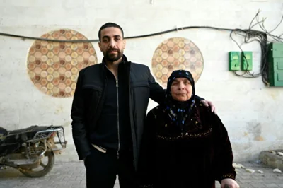 Freed Syrian prisoner Ghazi Mohammed al-Mohammed, 39, with his mother Fatima Abd al-Ghany -- 'It's like he's not my son' anymore, she says