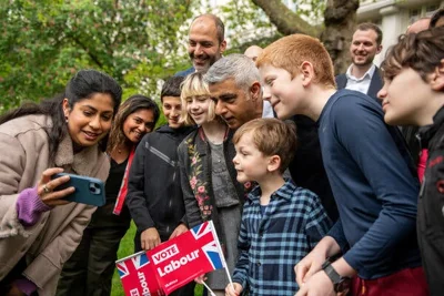 Sadiq Khan taking a selfie with a group of supporters.
