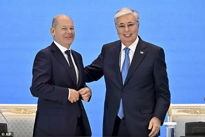 German Chancellor Olaf Scholz, left, and Kazakh President Kassym-Jomart Tokayev pose for a photo during their meeting