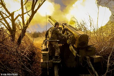 A serviceman of 24th Mechanised brigade named after King Danylo of the Ukrainian Armed Forces fires a 2s5 "Hyacinth-s" self-propelled howitzer towards Russian troops at a front line