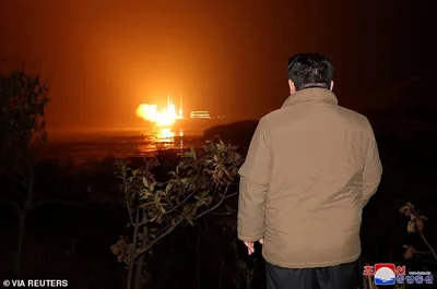 North Korean leader Kim Jong Un looks on as a rocket carrying a spy satellite Malligyong-1 is launched in North Gyeongsang Province, North Korea on November 21 2023