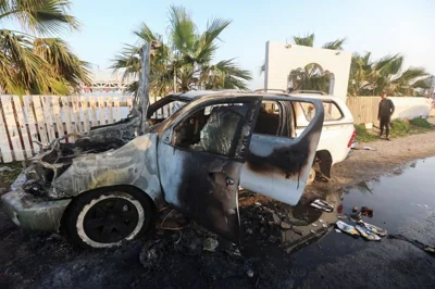 A person looks at a vehicle where employees from the World Central Kitchen (WCK), including foreigners, were killed in an Israeli airstrike, according to the NGO as the Israeli military said it was conducting a thorough review at the highest levels to understand the circumstances of this "tragic" incident, amid the ongoing conflict between Israel and Hamas, in Deir Al-Balah, in the central Gaza, Strip April 2, 2024.